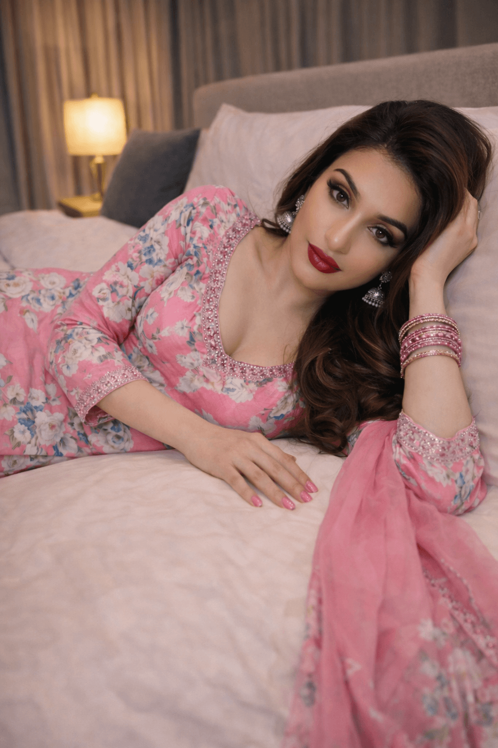 A model wearing The "Rosy Romance" Floral suit, showcasing its vibrant pink with floral motifs.